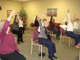 Seniors practice chair pose in a class led by Jenny Hellman, owner of Full Circle Yoga KC.