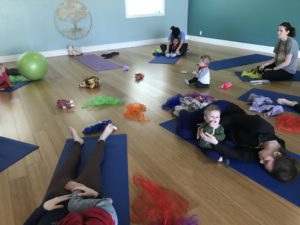 Caregivers and children participate in a Parent and Little Movers toddler yoga class at Full Circle Yoga, a family-centered yoga studio