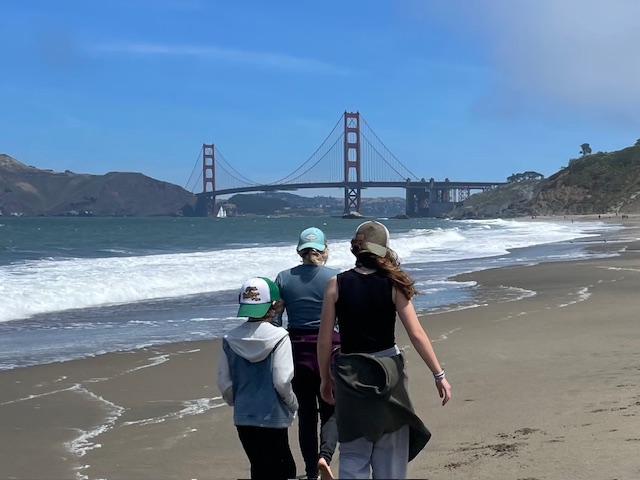 parent and children walking towards a bridge