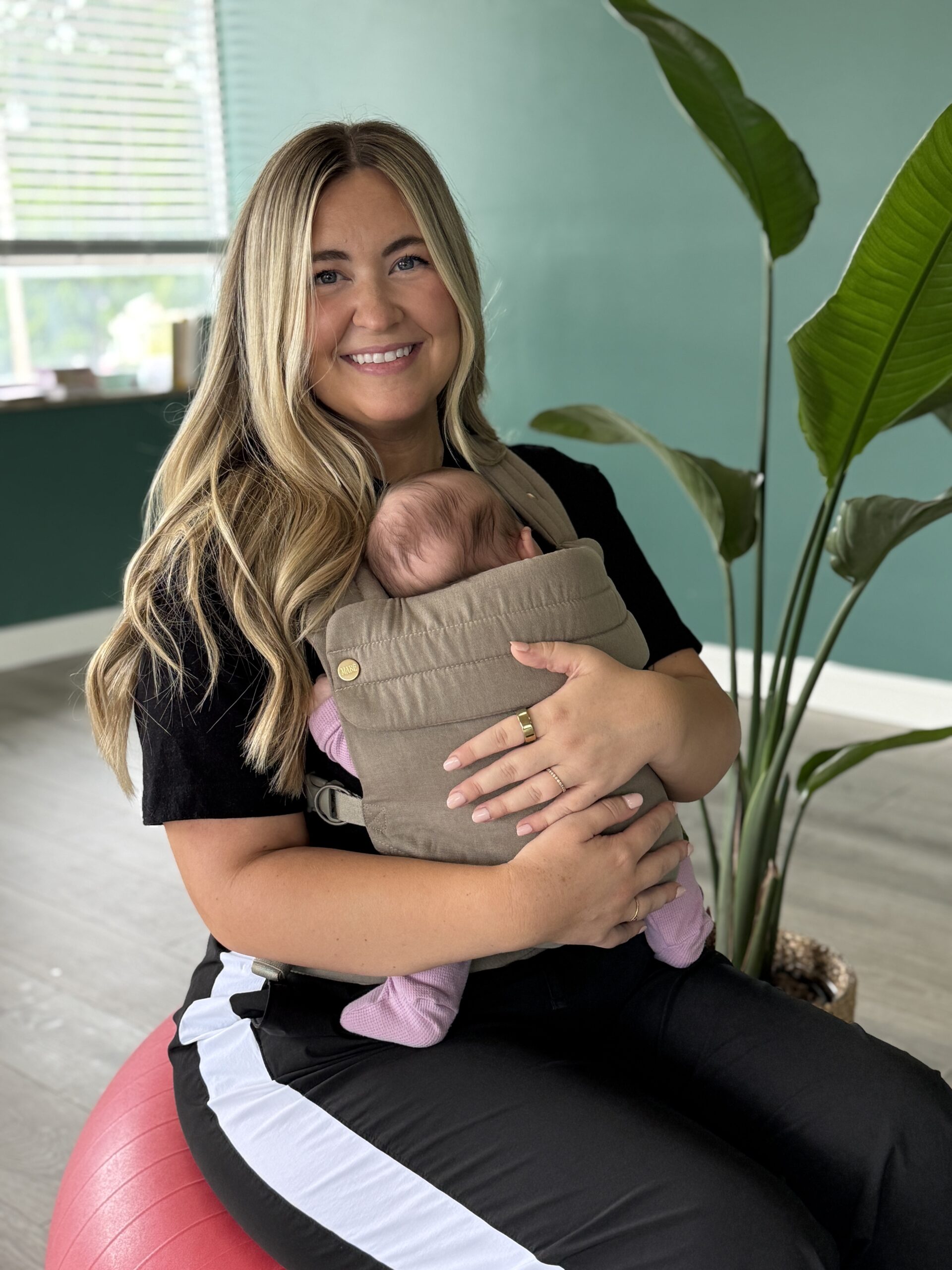 picture of a mom babywearing at Full Circle Yoga KC
